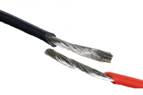 Close-up of stripped black and red speaker wires showing exposed strands